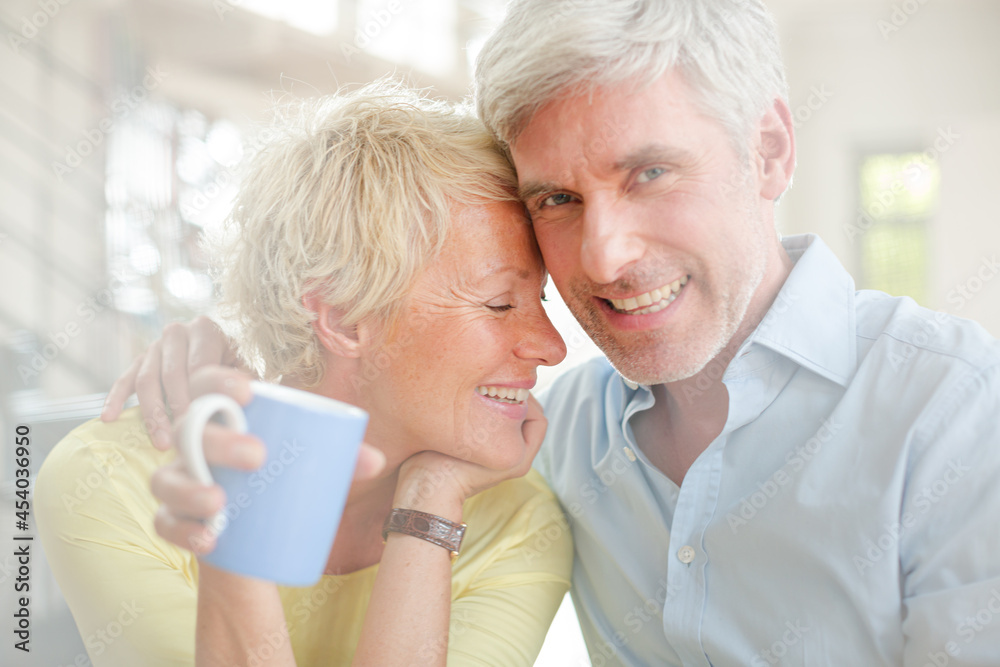Older couple hugging with coffee cup Older couple hugging with coffee cup
