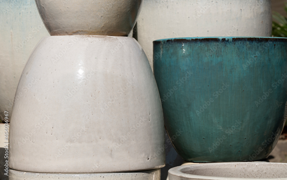 Closeup of white and blue ceramic plant pots under sunlight Closeup of white and blue ceramic plant pots under sunlight