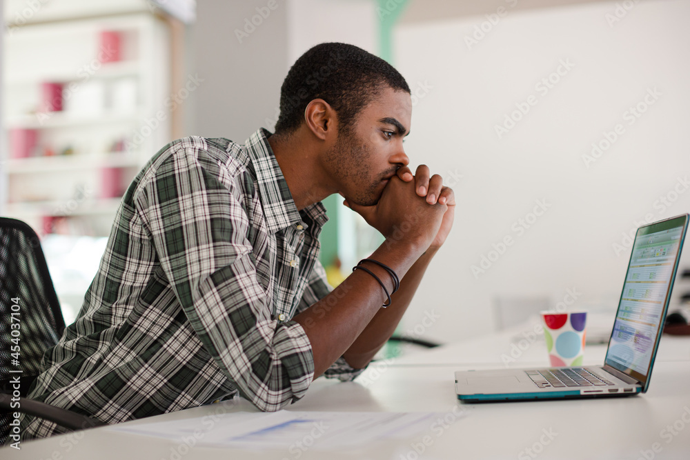 Man working on laptop at office Man working on laptop at office