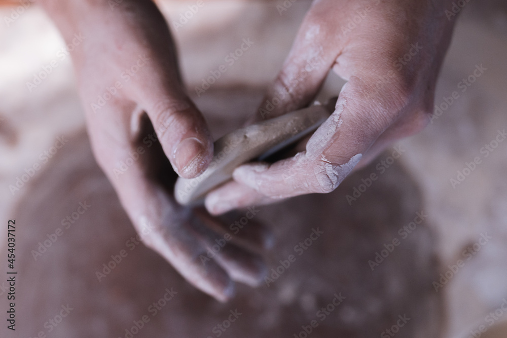 Vertical photo of dirty hands working with clay Vertical photo of dirty hands working with clay