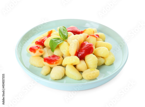 Delicious gnocchi with tomato sauce in plate on white background