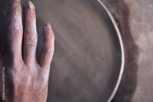 Close up of hand and half ceramic plate