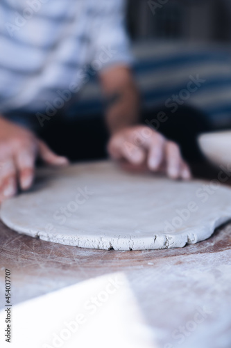 Close up of a man making ceramic plate