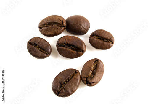 Several roasted arabica beans isolated on white background.