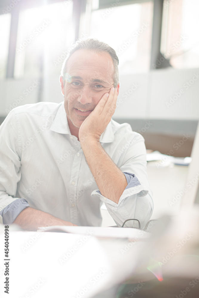 Businessman reading paperwork at home office desk Businessman reading paperwork at home office desk