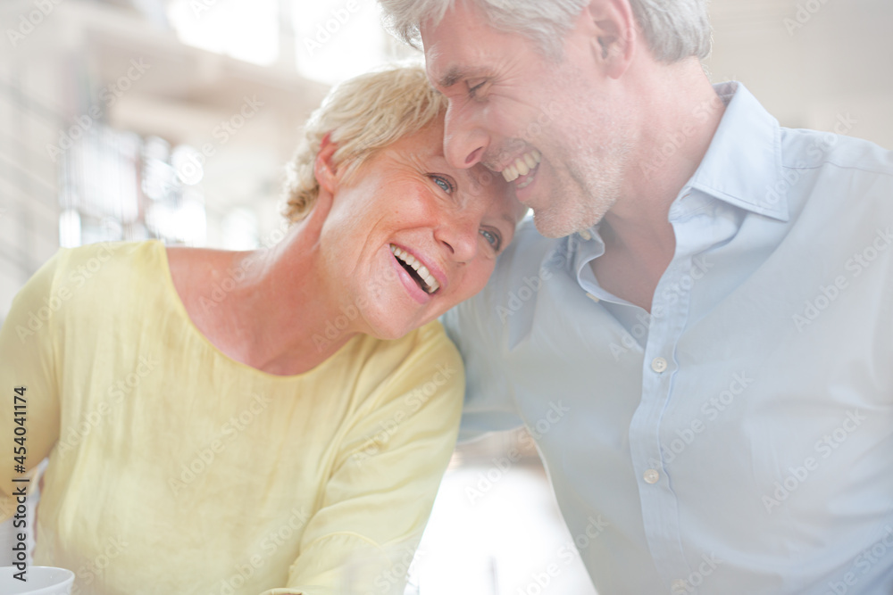 Older couple hugging with coffee cup Older couple hugging with coffee cup