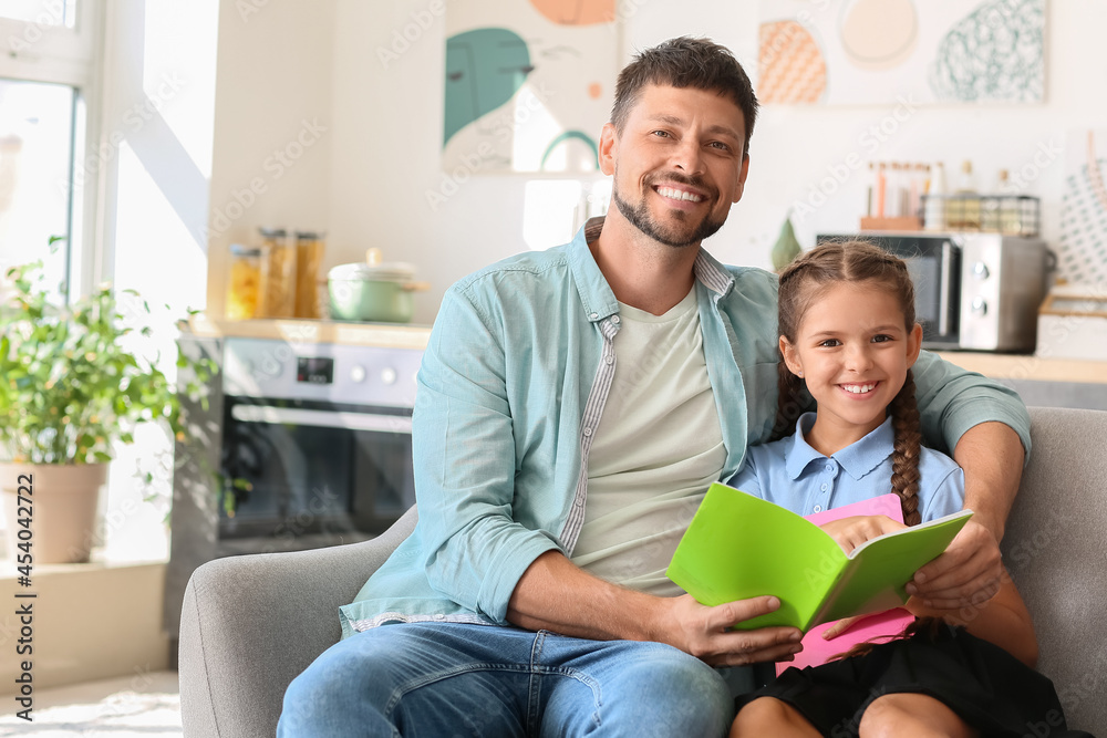 Father and his little daughter with notebook at home Father and his little daughter with notebook at home