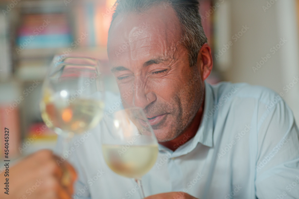Older man drinking white wine Older man drinking white wine