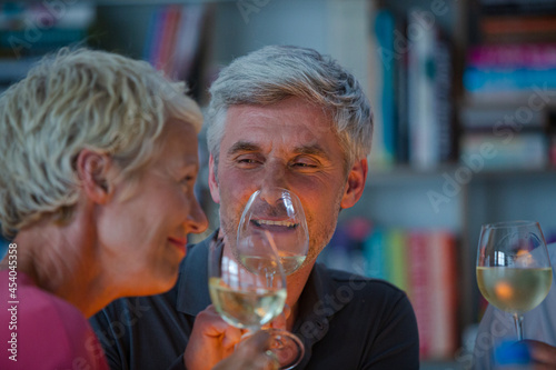 Older friends tasting white wine