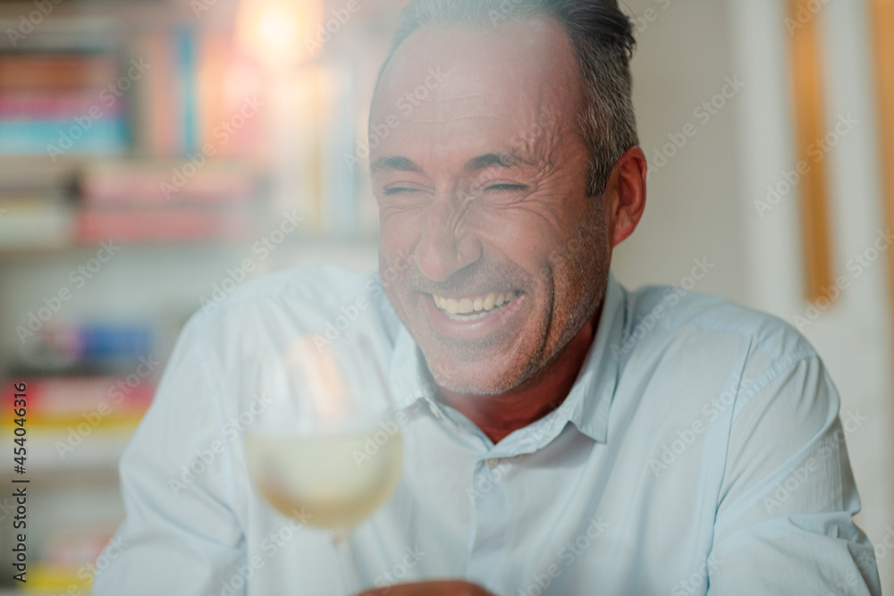Older man drinking white wine