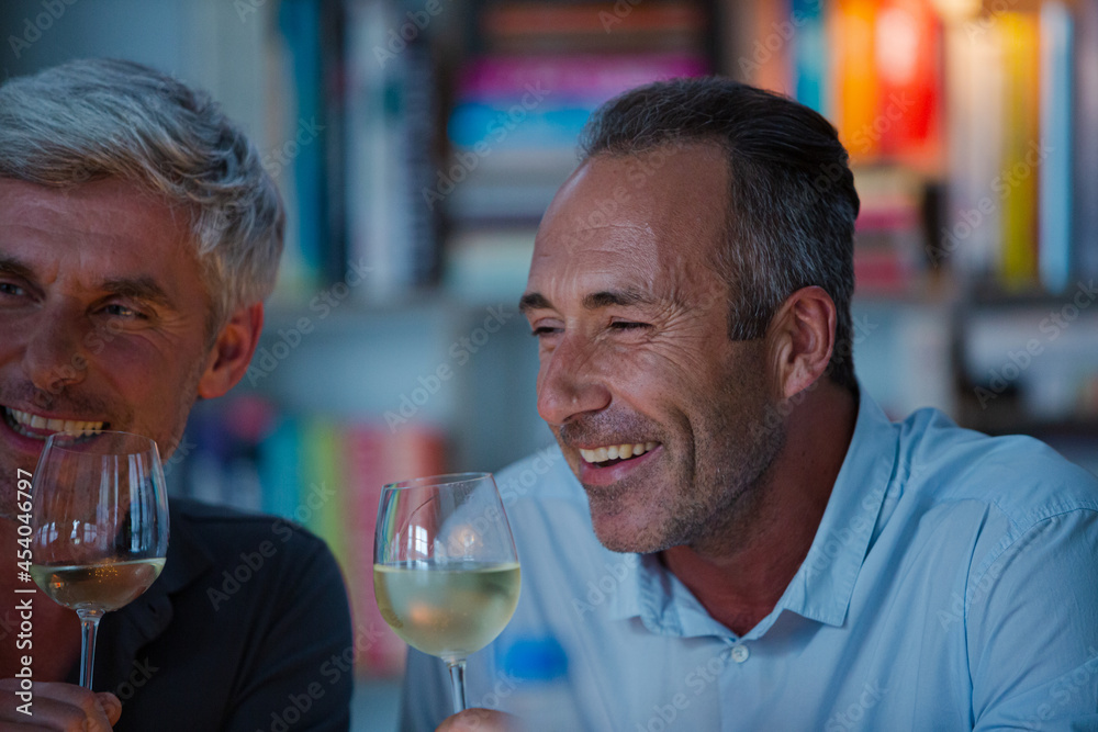 Older friends tasting white wine Older friends tasting white wine