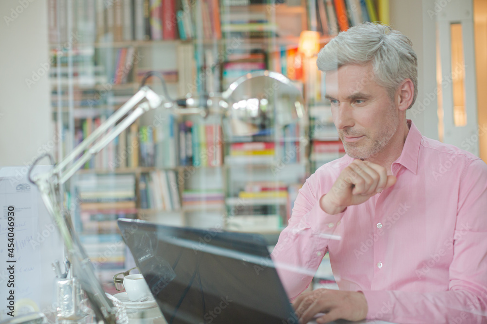 Businessman using laptop in home office Businessman using laptop in home office