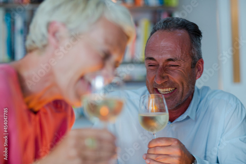 Older friends drinking white wine