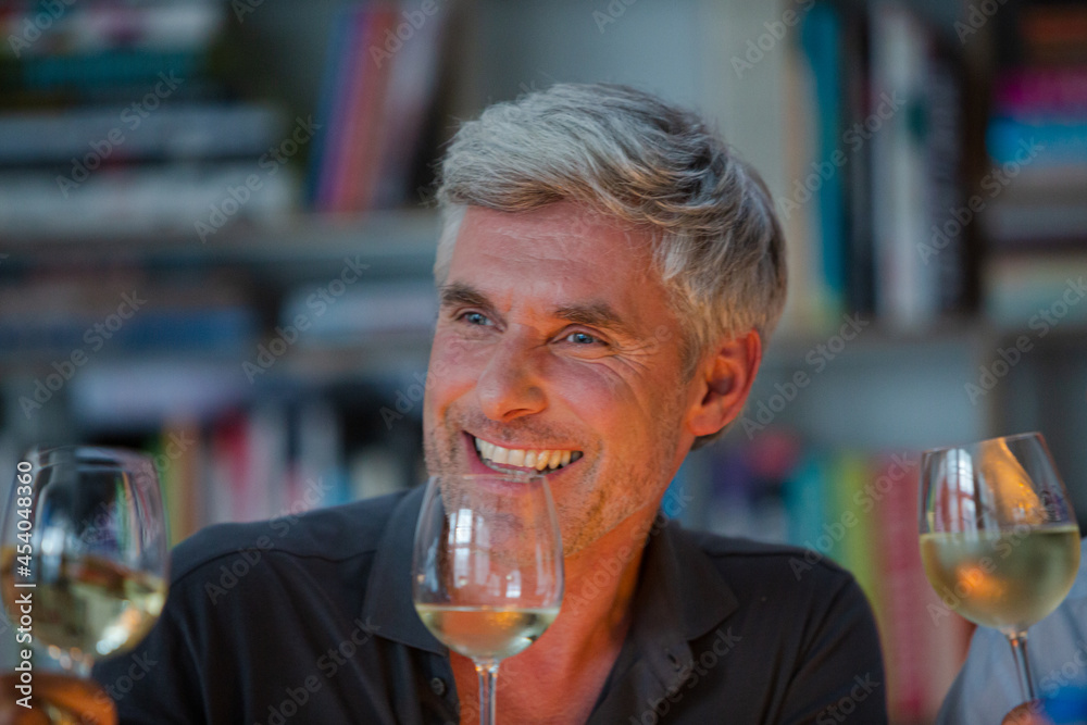 Older friends tasting white wine Older friends tasting white wine
