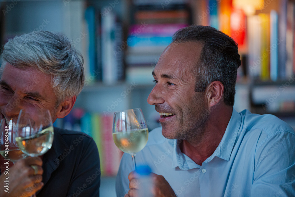 Older friends tasting white wine Older friends tasting white wine