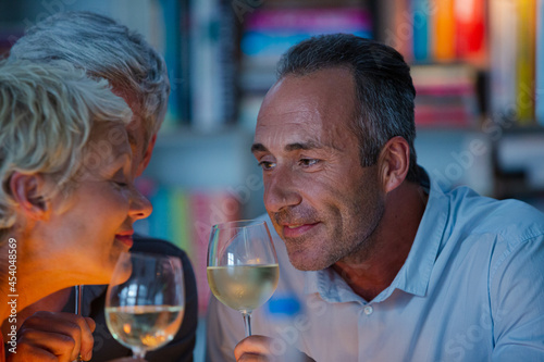 Older friends tasting white wine