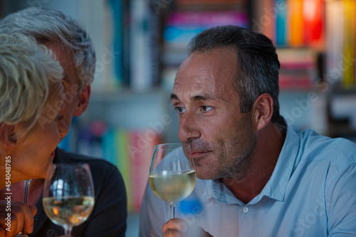 Older friends tasting white wine