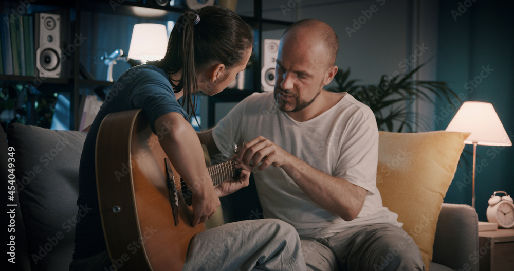 Woman learning how to play guitar