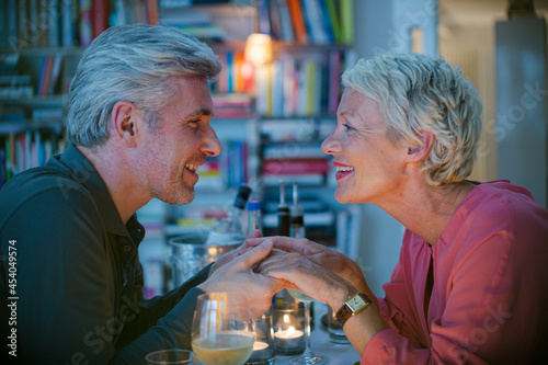 Close up of romantic older couple holding hands