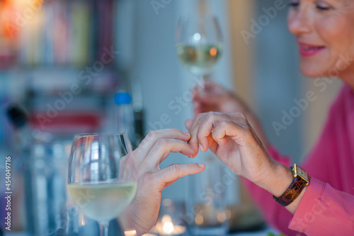 Close up of romantic older couple holding hands