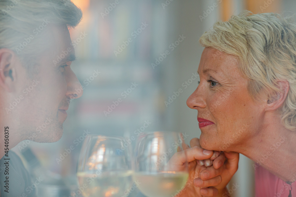 Older romantic couple drinking white wine Older romantic couple drinking white wine