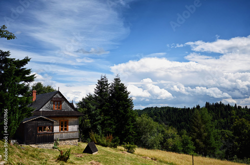 Clouds over the vilage house in Ochotnica Gorna vilage during summer day © Maciej Gillert