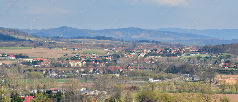 Panorama of Klodzko and the Sudety Mountains, view from the hill near the forest.