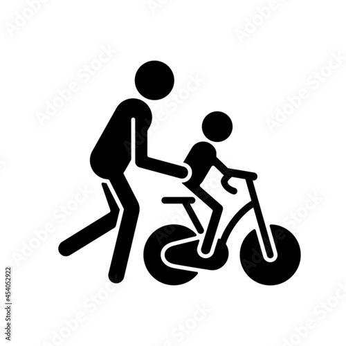 Learning to ride bike black glyph icon. Building kid cycling skills. Fun family togetherness time. Increasing child coordination. Silhouette symbol on white space. Vector isolated illustration