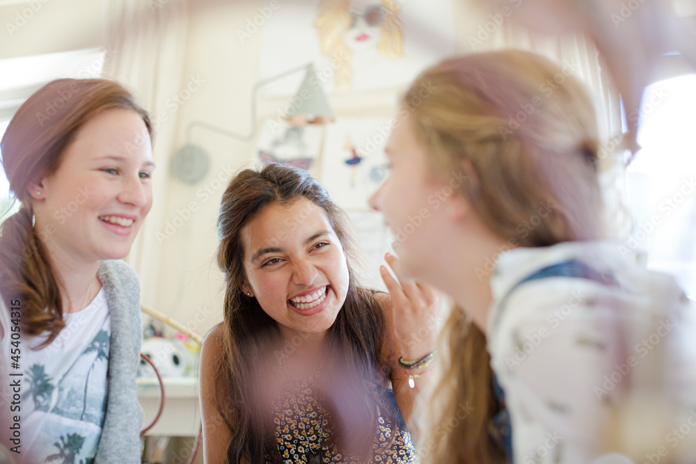 Three teenage girls gossiping in room Three teenage girls gossiping in room