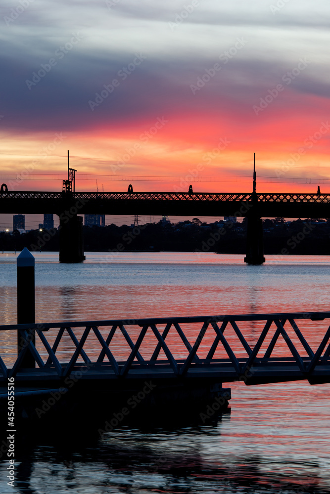 Silhouette of bridge at sunset over Parramatta River, Sydney, Australia.