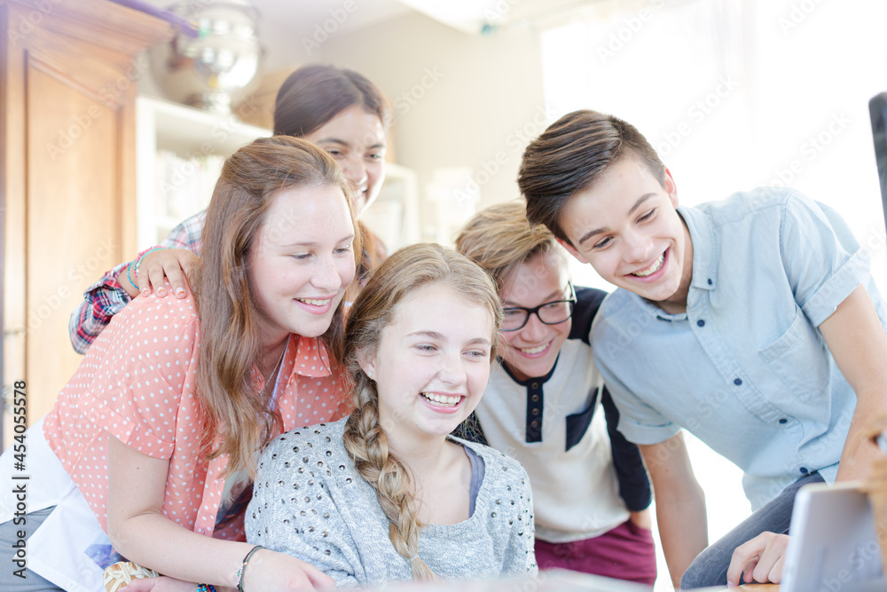 Group of teenagers waving while communicating via internet Group of teenagers waving while communicating via internet