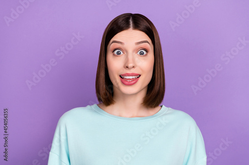 Photo portrait amazed staring girl wearing blue sweatshirt isolated pastel violet color background