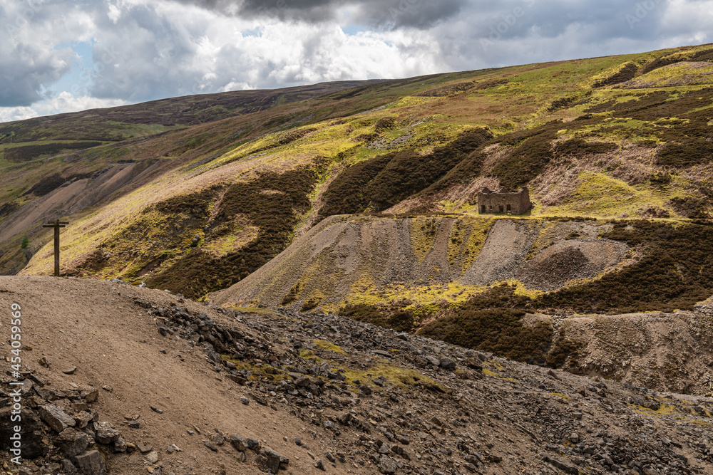 The remains of Bunton Mine with the Gunnerside Gill landscape, near Gunnerside, North Yorkshire, England, UK The remains of Bunton Mine with the Gunnerside Gill landscape, near Gunnerside, North Yorkshire, England, UK