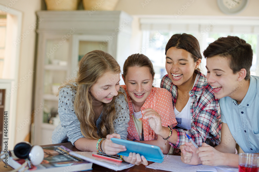Group of smiling teenagers taking selfie in dining room Group of smiling teenagers taking selfie in dining room