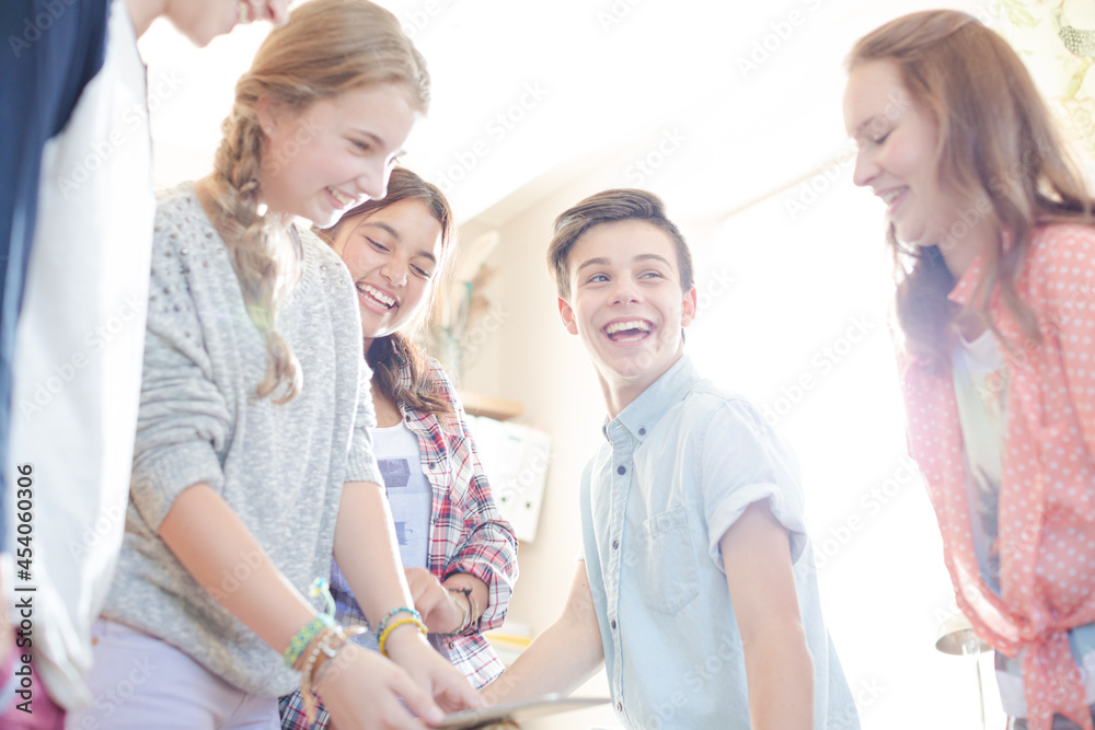Group of teenagers using together digital tablet Group of teenagers using together digital tablet
