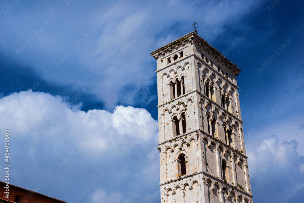 Saint Micheal in Foro Church medieval bell tower among clouds. Romanesque belfry erected in the 13th century in the city of Lucca, Tuscany Saint Micheal in Foro Church medieval bell tower among clouds. Romanesque belfry erected in the 13th century in the city of Lucca, Tuscany