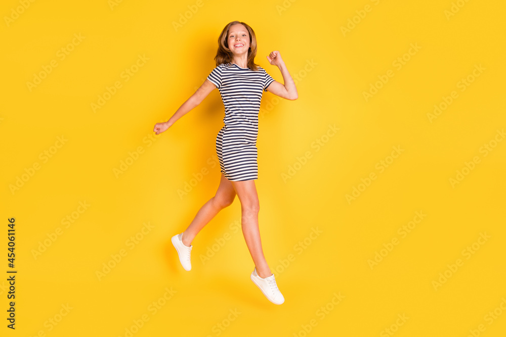 Full size profile portrait of cheerful active little lady toothy smile look camera isolated on yellow color background