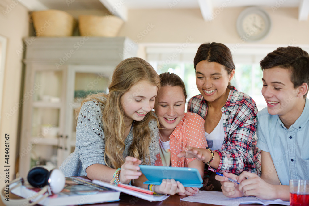 Fototapeta premium Group of smiling teenagers taking selfie in dining room