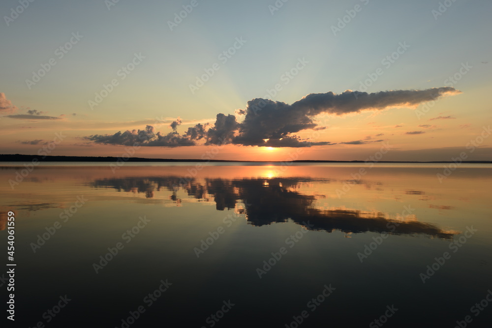 reflection in the lake water of the sky at sunset