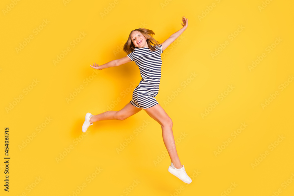 Full size profile photo of nice crazy girl arms flying beaming smile look camera isolated on yellow color background