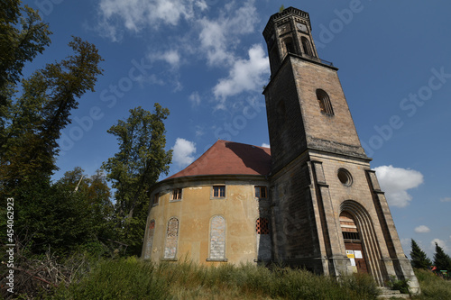 Abandoned evangelical old church in a field on a sunny day in Zeliszow, Poland