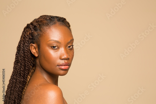 Studio portrait of shirtless woman with braided hair