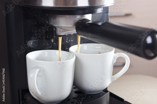 Making two cups of coffee in carob coffee machine.