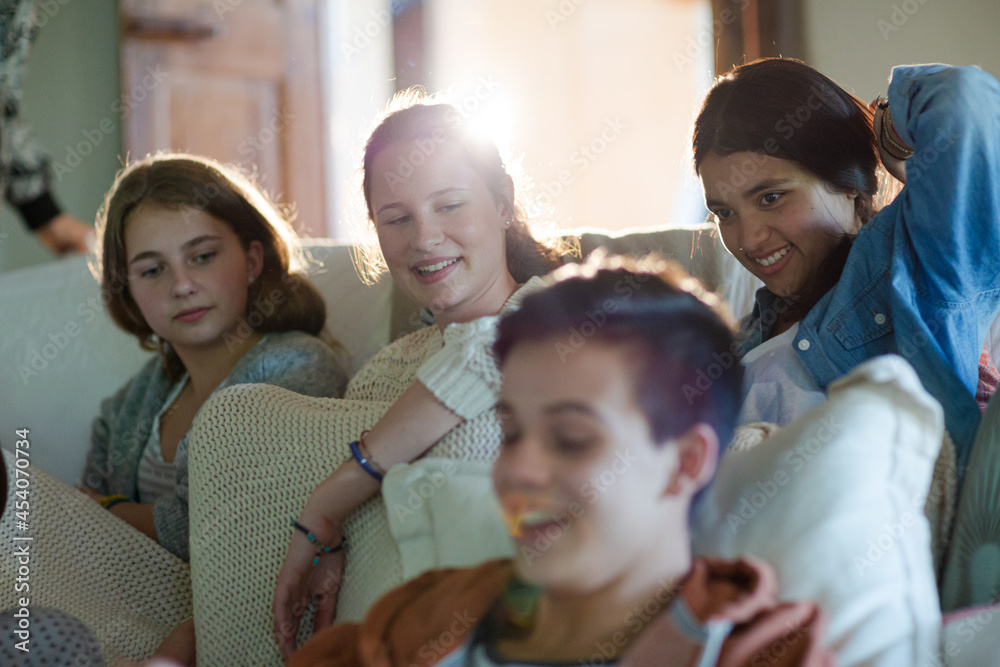 Group of teenagers having fun while watching tv on sofa Group of teenagers having fun while watching tv on sofa