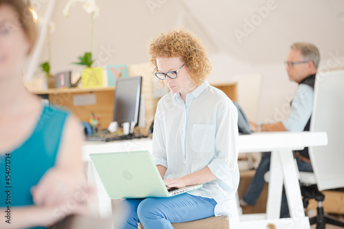 Woman using laptop in office