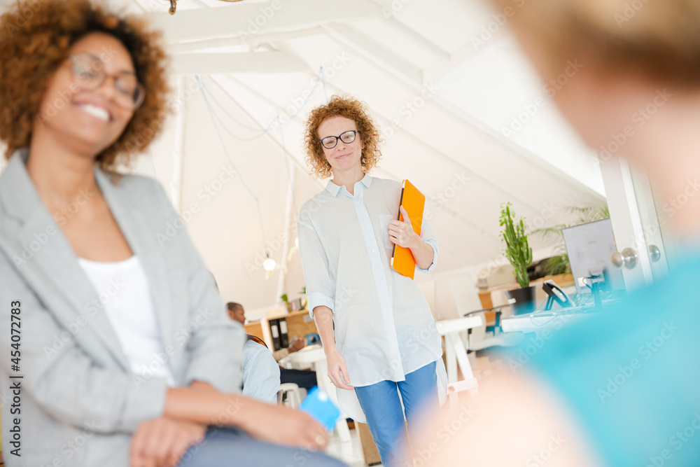 Fototapeta premium Woman walking and carrying laptop, joining colleague from office