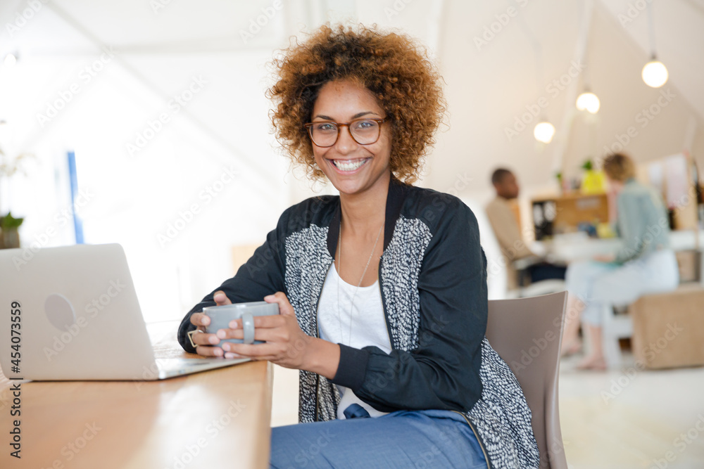 Fototapeta premium Office worker with coffee using laptop