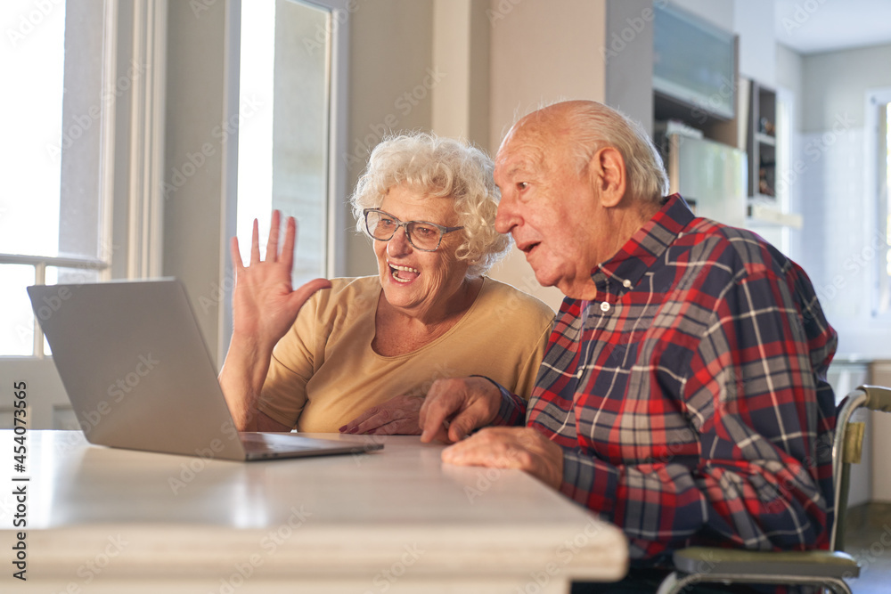 Happy senior couple at the computer making video call Happy senior couple at the computer making video call