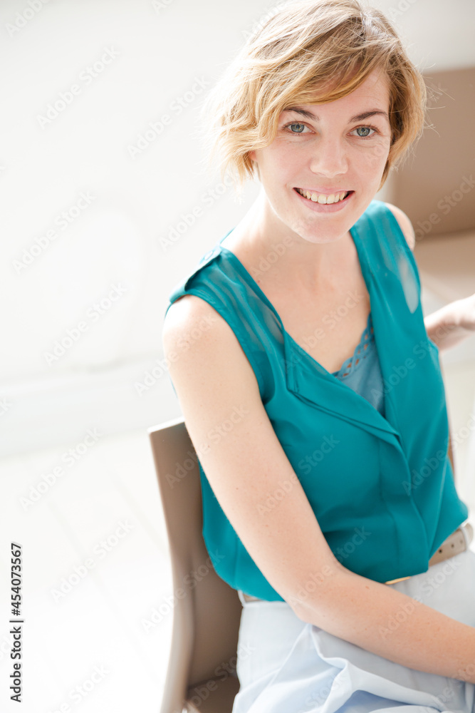Portrait of young woman smiling at office