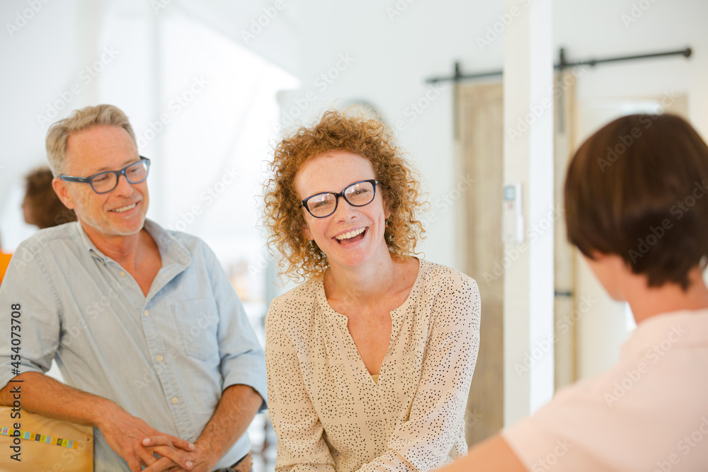 Fototapeta premium Office workers talking and smiling